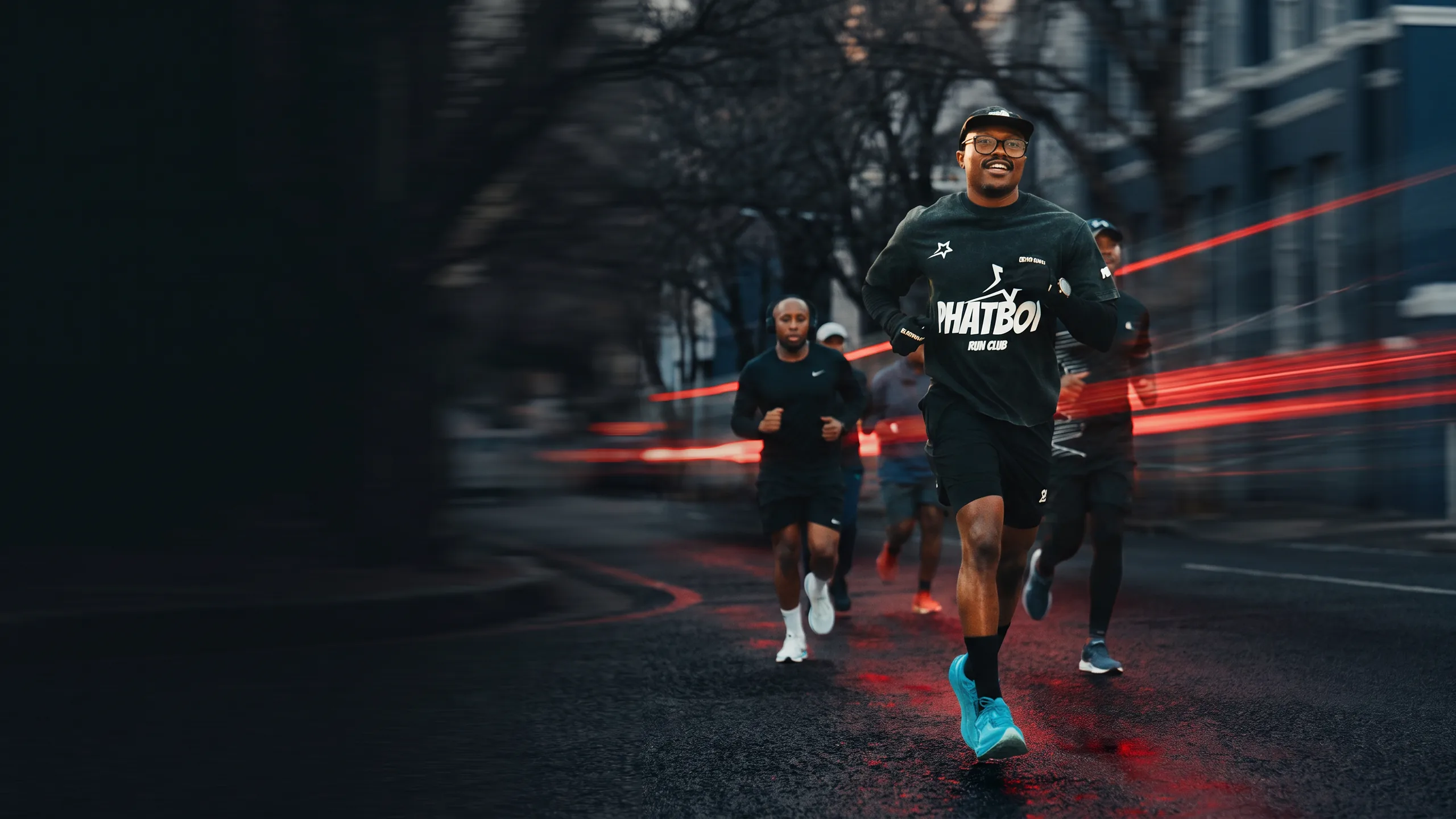 Members of PhatBoi Run Club running together through the city at night